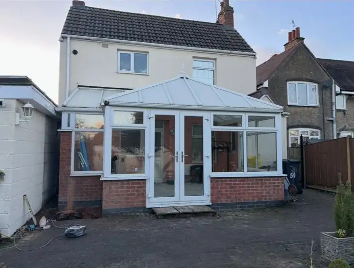 Original PVC conservatory at the rear of a Coventry property before removal and replacement with a full rear extension.