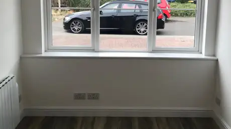 Completed garage conversion in Coventry showing modern finishes and view out of the newly installed extension window.