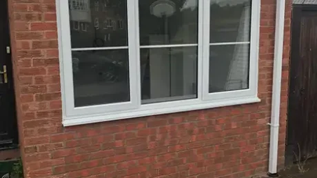External view of a garage conversion in Coventry showing a newly installed front window and matching brickwork.