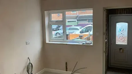 Nearly completed garage conversion living space in Coventry with plastered walls, recessed lighting and new flooring.